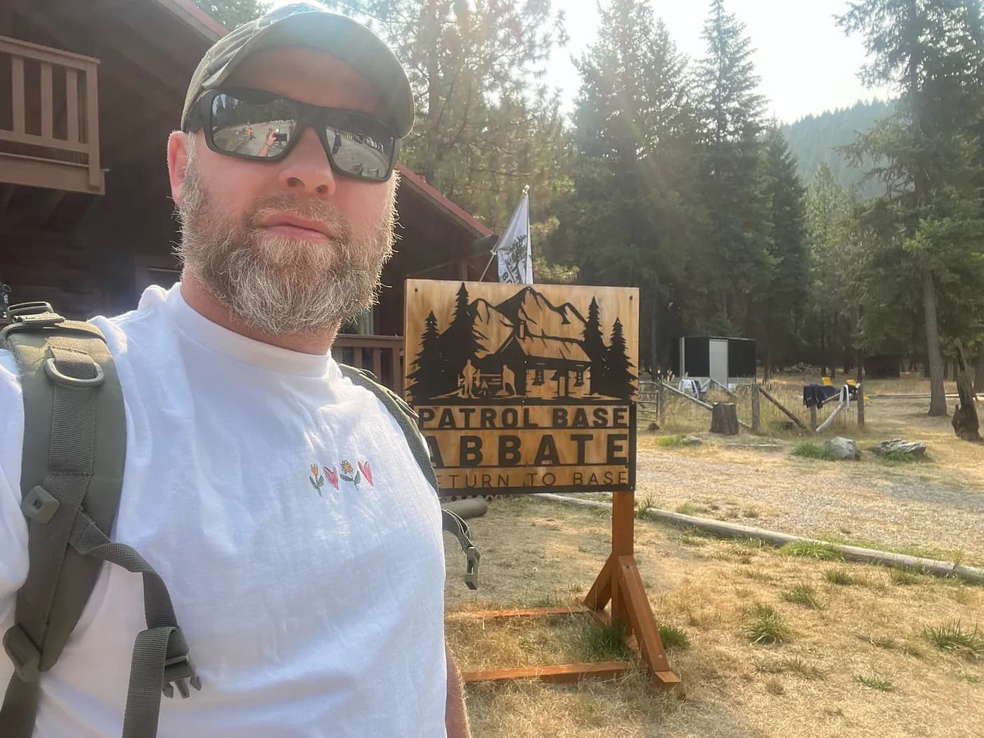 Smiling woman giving a piggyback ride to a laughing young girl.